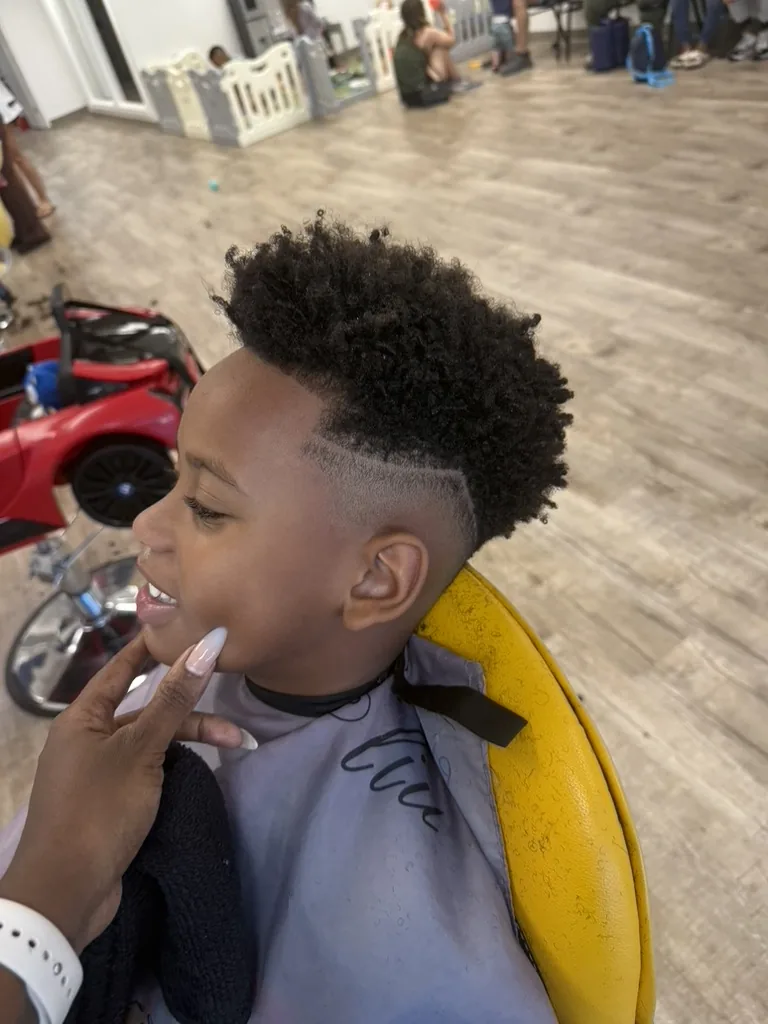 Happy child enjoying the Sniggles & Giggles salon experience