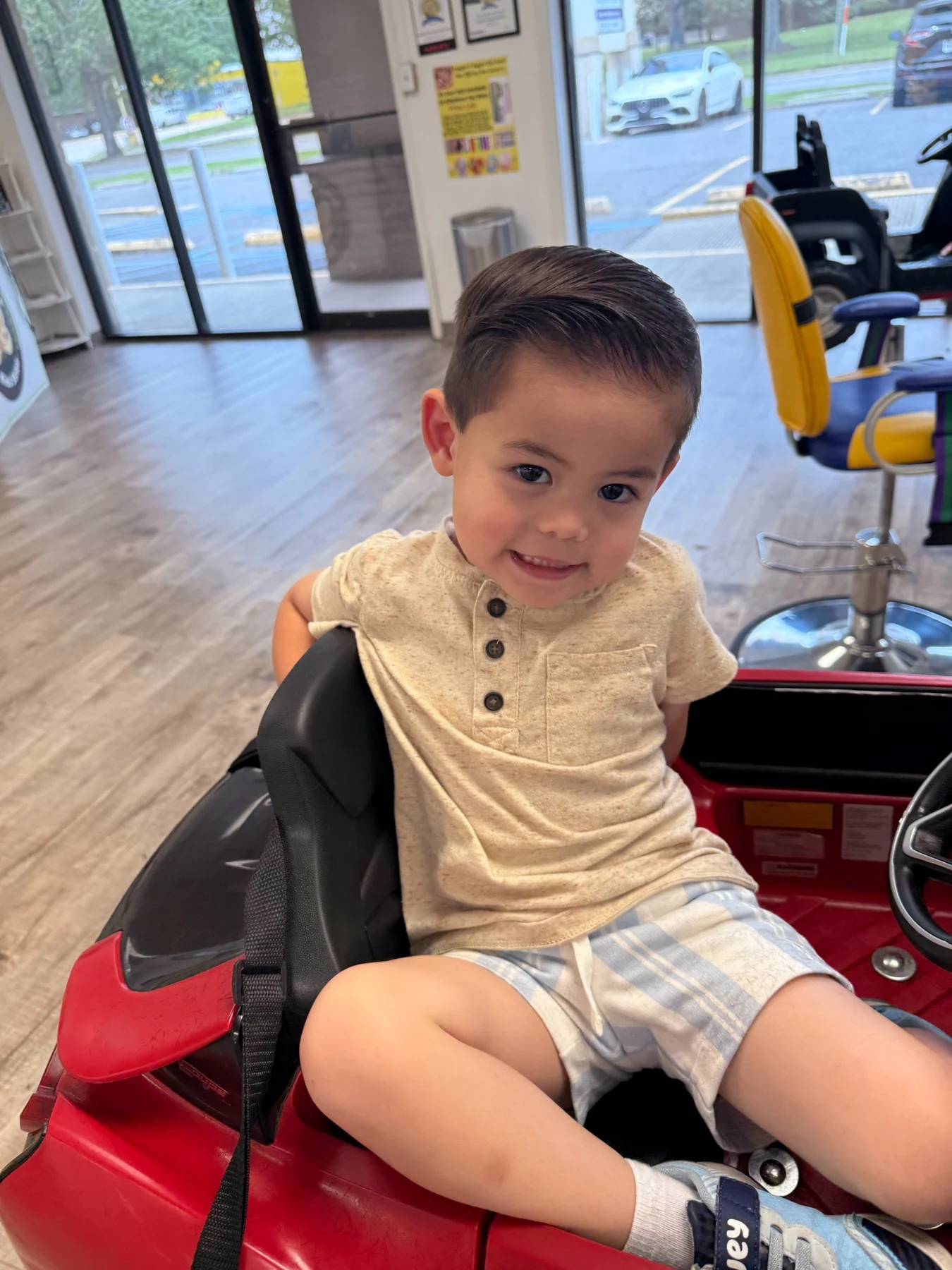 Child relaxing in a themed salon car chair