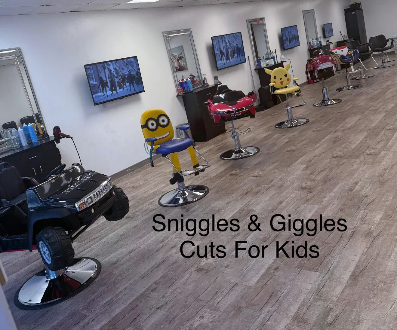 Inside Sniggles & Giggles Kids Salon with colorful themed styling chairs